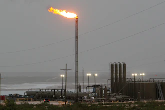 Strong winds kick up dust as a facility in the Permian Basin flares natural gas east of Carlsbad, N.M., on Monday, May 19, 2025.