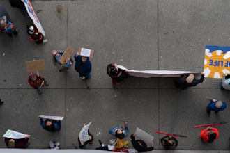 People hold signs during a protest outside the annual Alaska Sustainable Energy Conference on Tuesday, June 3, 2025, in Anchorage, Alaska.