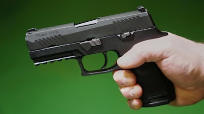 A Sig Sauer P320 handgun is held by a Maine gun shop owner, Tuesday, June 17, 2025.