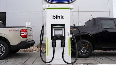 Electric vehicle chargers sit outside a Ford dealership, Jan. 21, 2024, in Broomfield, Colo.