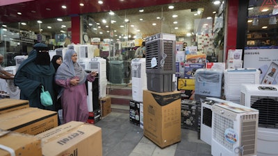 People purchase air conditioners at a shop on a hot summer day in Srinagar, Indian-controlled Kashmir, June 24, 2025.