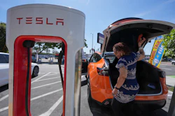 Janelle Lowe prepares to charge her electric vehicle at a station May 22, 2025, in Long Beach, Calif.