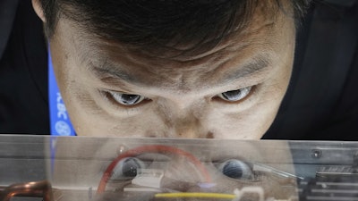 A visitor looks at Quantum-X800 infiniBand networking platform at the Nvidia booth during the 3rd China International Supply Chain Expo at the China International Exhibition Center, in Beijing, China, Friday, July 18, 2025.
