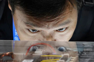 A visitor looks at Quantum-X800 infiniBand networking platform at the Nvidia booth during the 3rd China International Supply Chain Expo at the China International Exhibition Center, in Beijing, China, Friday, July 18, 2025.