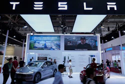 People visit a booth of Tesla during the 3rd China International Supply Chain Expo at the China International Exhibition Center, in Beijing, China, Friday, July 18, 2025.