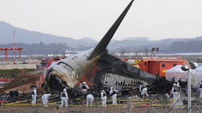 Rescue team members work at the site of a plane crash at Muan International Airport in Muan, South Korea on Dec. 31, 2024.