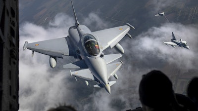 Spanish Air Force Eurofighter Typhoon military fighter jets, left, and Italian Air Force Eurofighter Typhoon military fighter jets, right, participating in NATO's Baltic Air Policing Mission operate in Lithuanian airspace,, Sept.12, 2023.