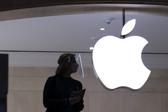 An Apple store employee stands inside the store in New York on Feb. 5, 2021.