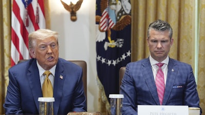 President Donald Trump, left, with Defense Secretary Pete Hegseth, right, during a cabinet meeting at the White House, Tuesday, July 8, 2025, in Washington.