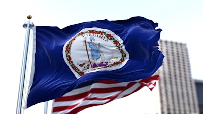Virginia state flag waving in front of the U.S. flag.