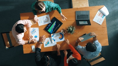 Business team analyzing data charts as part of a startup.
