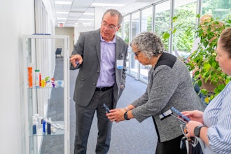 Sanner North America President Ted Mosler shows the company's product portfolio to City of Greensboro Councilmember Tammi Thurm.