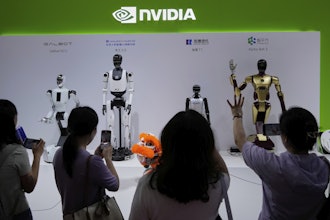 Visitors give commands to a robot at Nvidia's booth during the 3rd China International Supply Chain Expo at the China International Exhibition Center, in Beijing, China, Friday, July 18, 2025.