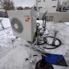 A condenser sits on the roof during the installation of a heat pump on Jan. 20, 2023, in Denver.
