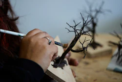 A miniature tree is painted in Pilar, Argentina, Wednesday, June 25, 2025.