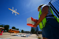 Masslie Arias, of DoorDash, prepares to load a delivery package on a hovering drone Thursday, July 31, 2025, in Frisco, Texas.