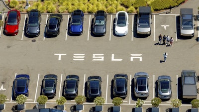 Tesla vehicles line a parking area at the company's Fremont, Calif., factory on Tuesday, Aug. 5, 2025.