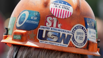 This is the back of the safety helmet worn by a steelworker listening to Pennsylvania Governor Josh Shapiro's meeting with media at the Clairton Coke Works, a U.S. Steel plant, in Clairton, Pa., Tuesday, Aug. 12, 2025.