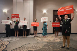 Air Canada executives leave after they are interrupted by Air Canada flight attendants during a press conference as a possible strike looms, in Toronto, on Thursday, Aug. 14, 2025.