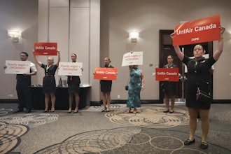 Air Canada executives leave after they are interrupted by Air Canada flight attendants during a press conference as a possible strike looms, in Toronto, on Thursday, Aug. 14, 2025.