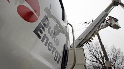 Duke Energy employees work on power lines in Charlotte, N.C., Feb. 14, 2012.