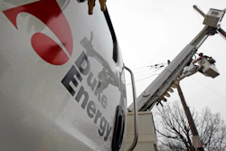 Duke Energy employees work on power lines in Charlotte, N.C., Feb. 14, 2012.
