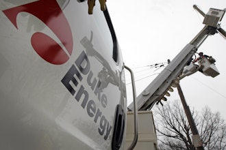 Duke Energy employees work on power lines in Charlotte, N.C., Feb. 14, 2012.