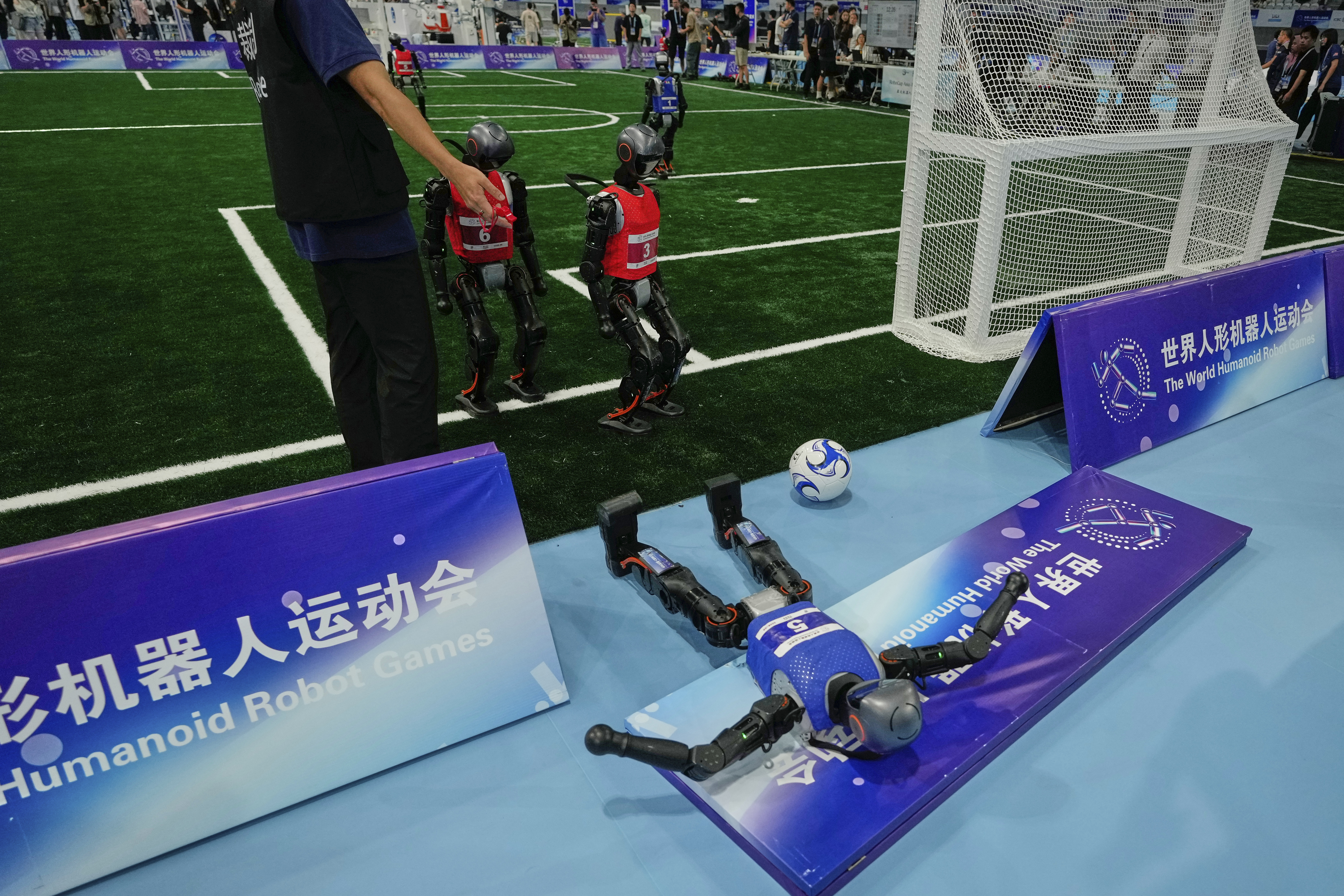A robot crashes during a soccer match at the World Humanoid Robot Games in Beijing, China, Friday, Aug. 15, 2025.