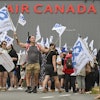 People protest outside Air Canada headquarters in Montreal, Sunday, Aug. 17, 2025, after the federal government is intervened in the labour dispute between the airline and the union representing its flight attendants, ordering binding arbitration and operations to resume.