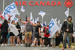 People protest outside Air Canada headquarters in Montreal, Sunday, Aug. 17, 2025, after the federal government is intervened in the labour dispute between the airline and the union representing its flight attendants, ordering binding arbitration and operations to resume.