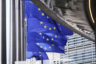 European Union flags flap in the wind outside EU headquarters in Brussels, Thursday, Aug. 21, 2025.