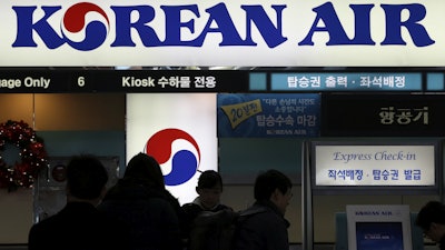 In this Dec. 16, 2014 photo, passengers wait to check in at the domestic check-in desk of Korean Air Lines Co. at Gimpo Airport in Seoul, South Korea.