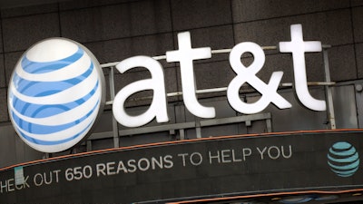In this Oct. 24, 2016, file photo, the AT&T logo is positioned above one of its retail stores, in New York.