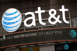 In this Oct. 24, 2016, file photo, the AT&T logo is positioned above one of its retail stores, in New York.