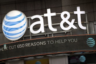 In this Oct. 24, 2016, file photo, the AT&T logo is positioned above one of its retail stores, in New York.