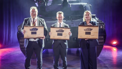 BAE Systems Hägglunds Managing Director Tommy Gustafsson-Rask, Czech Defence Minister Jana Černochová, and Swedish Defence Minister Pål Jonson in front of the first CV9030 MkIV vehicle.