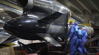 Workers inspect a Flamingo cruise missile at Fire Point's secret factory in Ukraine on Monday, Aug. 18, 2025.