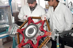 L3Harris engineers handling components of the electric thrusters.