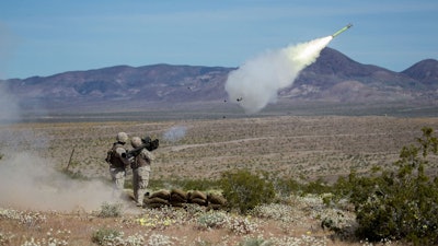 Military personnel firing the Stinger missile.