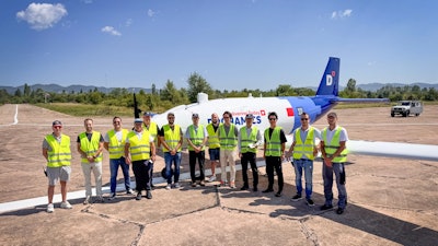 Kawasaki Motors and Dronamics teams in front of the Black Swan UAV in Sofia, Bulgaria