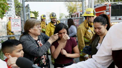 Student Marianna Torres, 11, center, cries as she evacuates Park Avenue Elementary School after jet fuel fell on the school in Cudahy, Calif., Jan. 14, 2020.