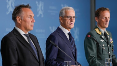 Norway's Prime Minister Jonas Gahr Store, center, flanked by Norway's Minister of Defense Tore O. Sandvik, left, and Chief of Defense Eirik Kristoffersen, reports on the status of the purchase of frigates from the United Kingdom, at the Prime Minister's Office in Oslo, Sunday, Aug. 31, 2025.