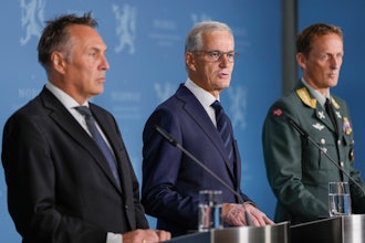 Norway's Prime Minister Jonas Gahr Store, center, flanked by Norway's Minister of Defense Tore O. Sandvik, left, and Chief of Defense Eirik Kristoffersen, reports on the status of the purchase of frigates from the United Kingdom, at the Prime Minister's Office in Oslo, Sunday, Aug. 31, 2025.