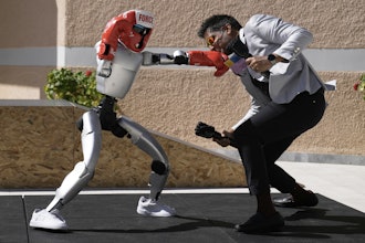 The Unitree G1 robot plays boxing with Aadeel Akhtar CEO and Founder of Psyonic at the first International Humanoid Olympiad at the Olympic Academy, in ancient Olympia, Greece, Monday, Sept. 1, 2025.