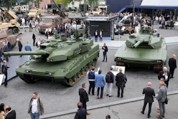 Visitors gather by a Leopard 2 A8 tank, left, and a Leopard 2A-RC-3.0 tank at the Eurosatory Defense and Security exhibition, Wednesday, June 19, 2024 in Villepinte, north of Paris, On Wednesday Sept. 3, 2025.