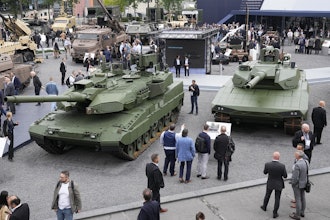 Visitors gather by a Leopard 2 A8 tank, left, and a Leopard 2A-RC-3.0 tank at the Eurosatory Defense and Security exhibition, Wednesday, June 19, 2024 in Villepinte, north of Paris, On Wednesday Sept. 3, 2025.