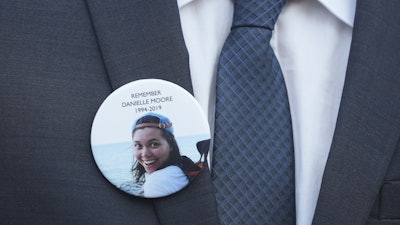 A family member wears a photo of a Boeing crash victim Danielle Moore before a hearing at federal court in Fort Worth, Texas, Wednesday, Sept. 3, 2025.