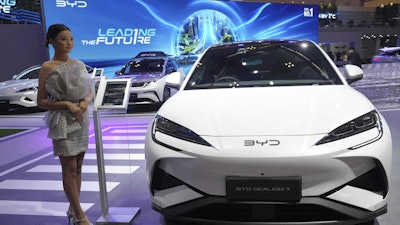 A model stands near a Sealion 7, an electric vehicle from Chinese automaker BYD, during the Gaikindo Indonesia International Auto Show in Tangerang, Indonesia, Wednesday, July 23, 2025.