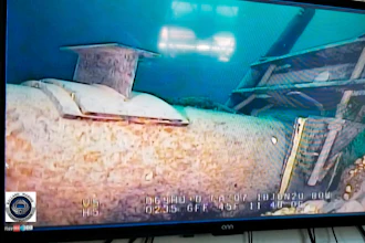 This photo provided by the Michigan Department of Environment, Great Lakes, and Energy in June 2020 shows damage to anchor support EP-17-1 on the east leg of the Enbridge Line 5 pipeline in the Straits of Mackinac in Michigan, displayed on a television screen.