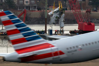 Crews pull up a part of a plane from the Potomac River near Ronald Reagan Washington National Airport, Monday, Feb. 3, 2025, in Arlington, Va.